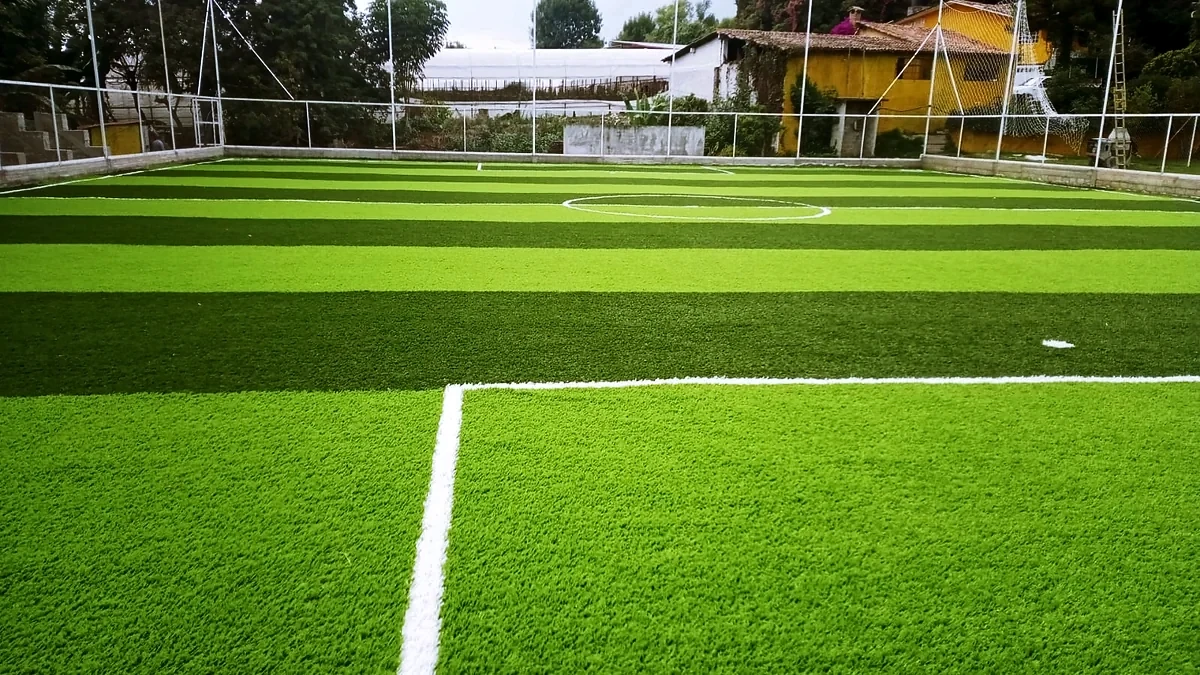 Cancha de fútbol 7 con pasto sintético en Futbol Club San Isidro, Coatepec Harinas, Estado de México: líneas de juego insertadas en el mismo pasto