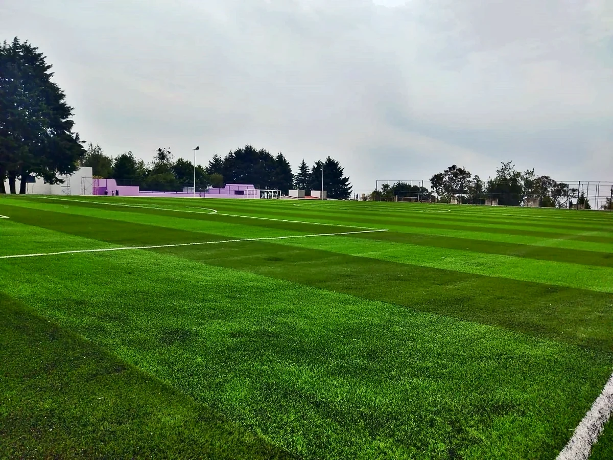 Cancha de fútbol soccer con pasto sintético en Unidad Deportiva Huitzilac, Morelos: pasto sintético deportivo recién cepillado