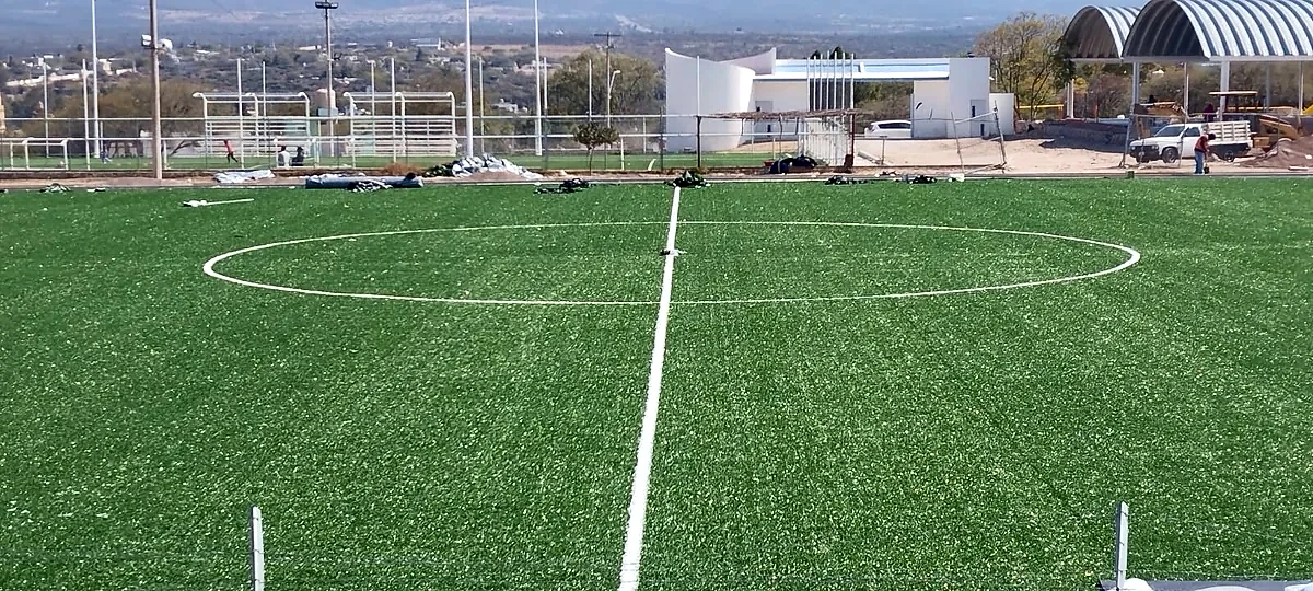 Cancha de fútbol soccer con pasto sintético en San Pablo Tolimán, Querétaro: pasto sintético deportivo recién cepillado