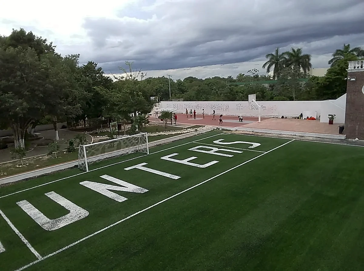 Campo de fútbol americano con pasto sintético en Colegio Álamos, Cancún