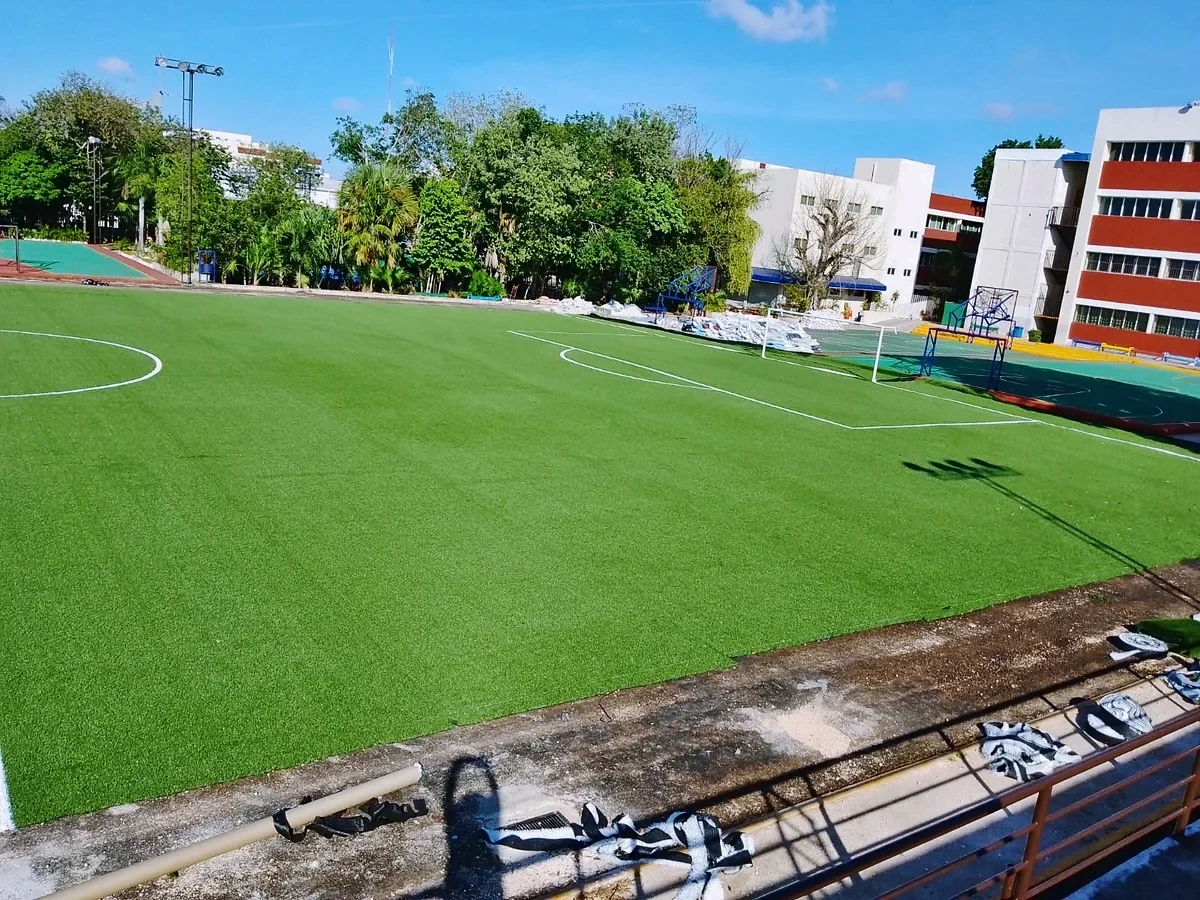 Cancha de fútbol 9 con pasto sintético en Colegio Boston, Cancún, Quintana Roo: vista de la cancha y su entorno